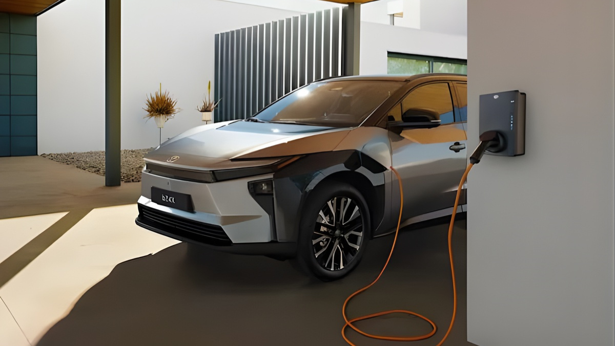 Electric vehicle charging at a modern home charger with an orange cable