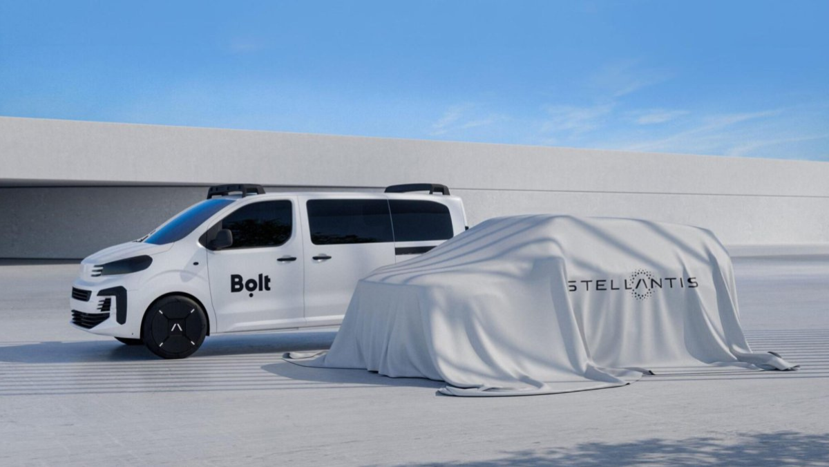 Bolt electric van beside covered Stellantis autonomous test vehicle