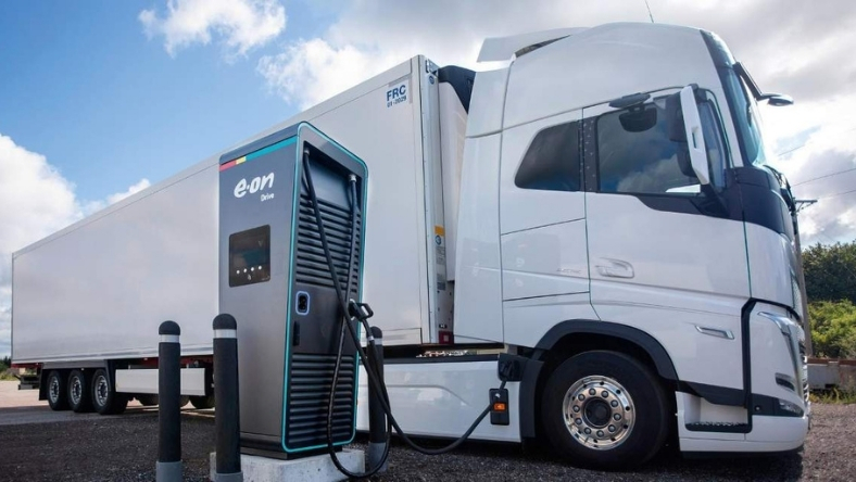 Electric truck charging station with battery storage unit beside a parked heavy-duty vehicle