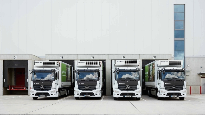 Electric trucks parked at logistics depot showing fleet electrification operations
