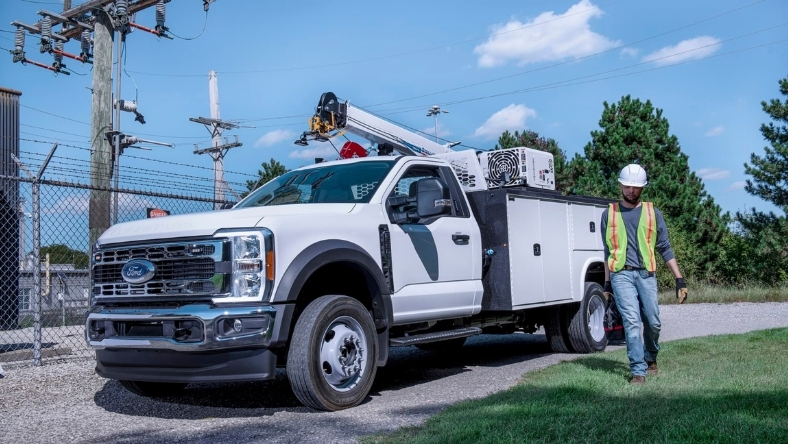 Ford Pro utility truck and technician at a power infrastructure site